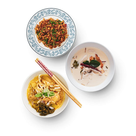 Three bowls of different dishes of TAAN THAI product on a white background